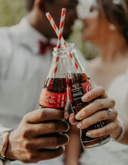 An image of two icon glass bottles of coca cola. Illustrating how the instant recognition aids in brand equity. 