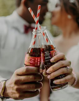 An image of two icon glass bottles of coca cola. Illustrating how the instant recognition aids in brand equity.